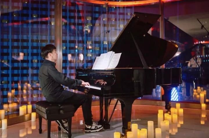 Concert view of Victor at a grand piano